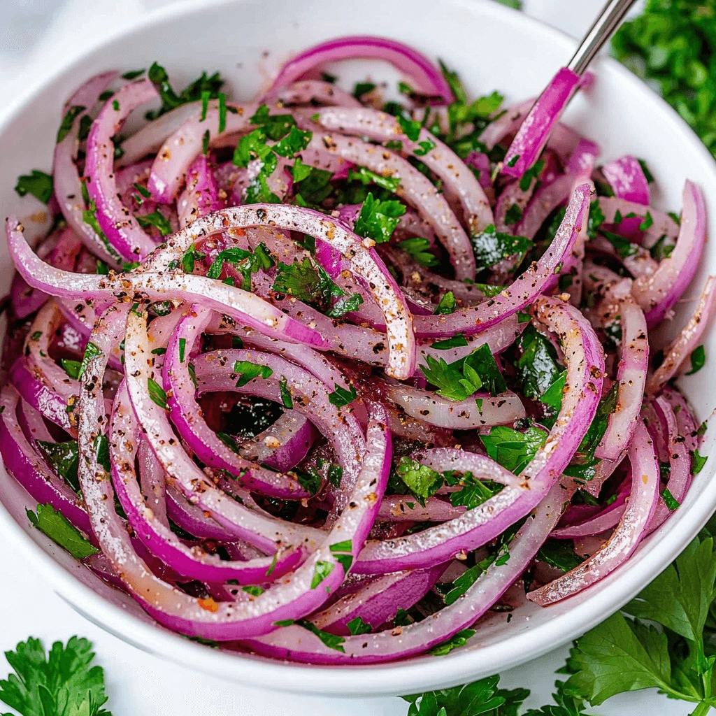 A vibrant bowl of sliced red onions mixed with fresh parsley, coated in a light dressing and seasoning.