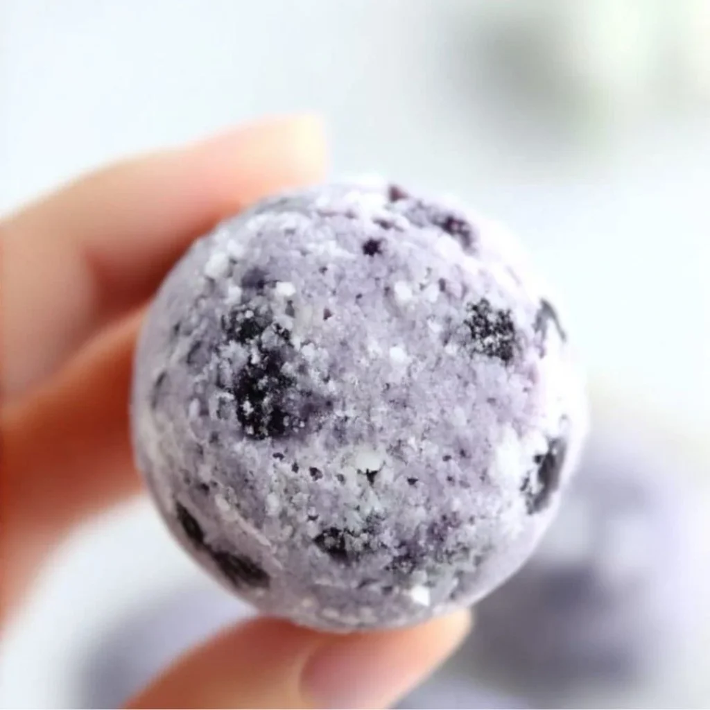 Delicious blueberry cheesecake protein balls ready to eat, healthy snack alternative.