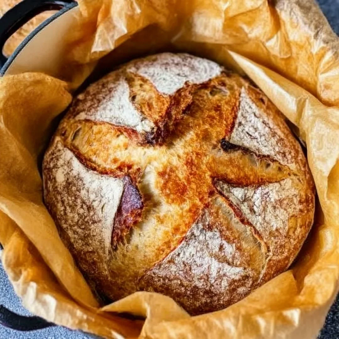 Freshly baked Easy Dutch Oven Bread loaves cooling on a wire rack.