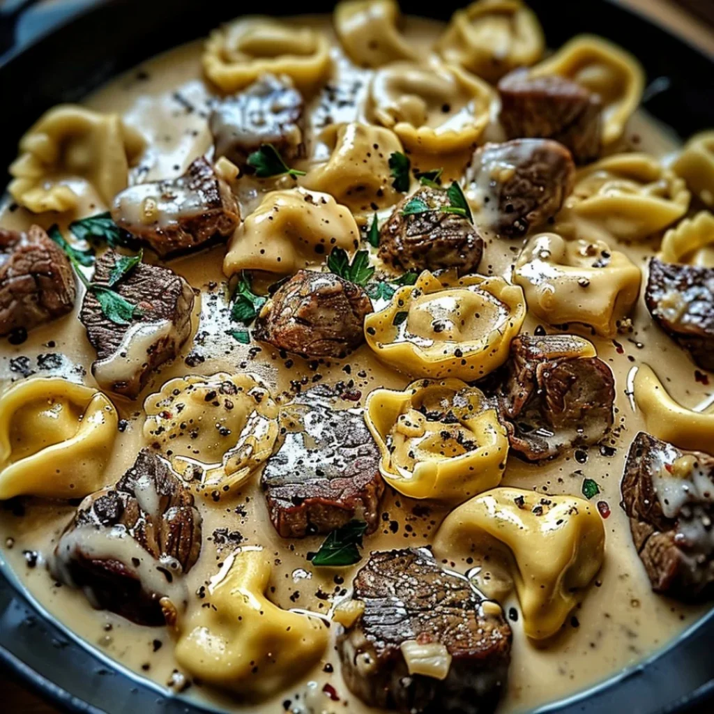 Delicious cracked garlic steak tortellini in creamy sauce on a plate