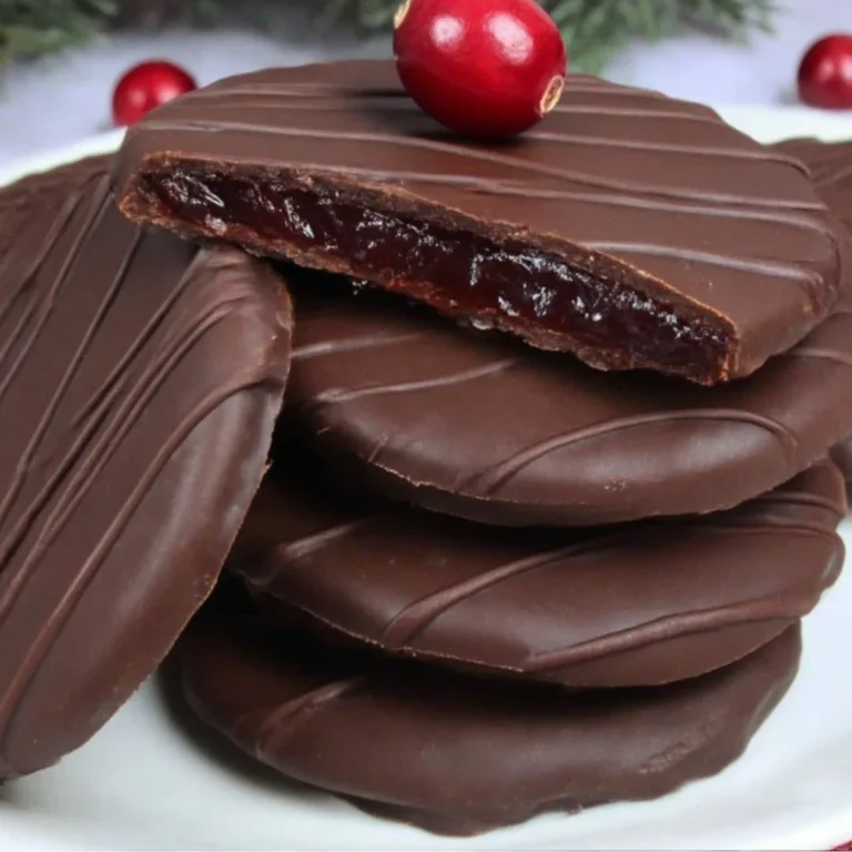Dark chocolate covered cranberry sauce bites on a decorative plate