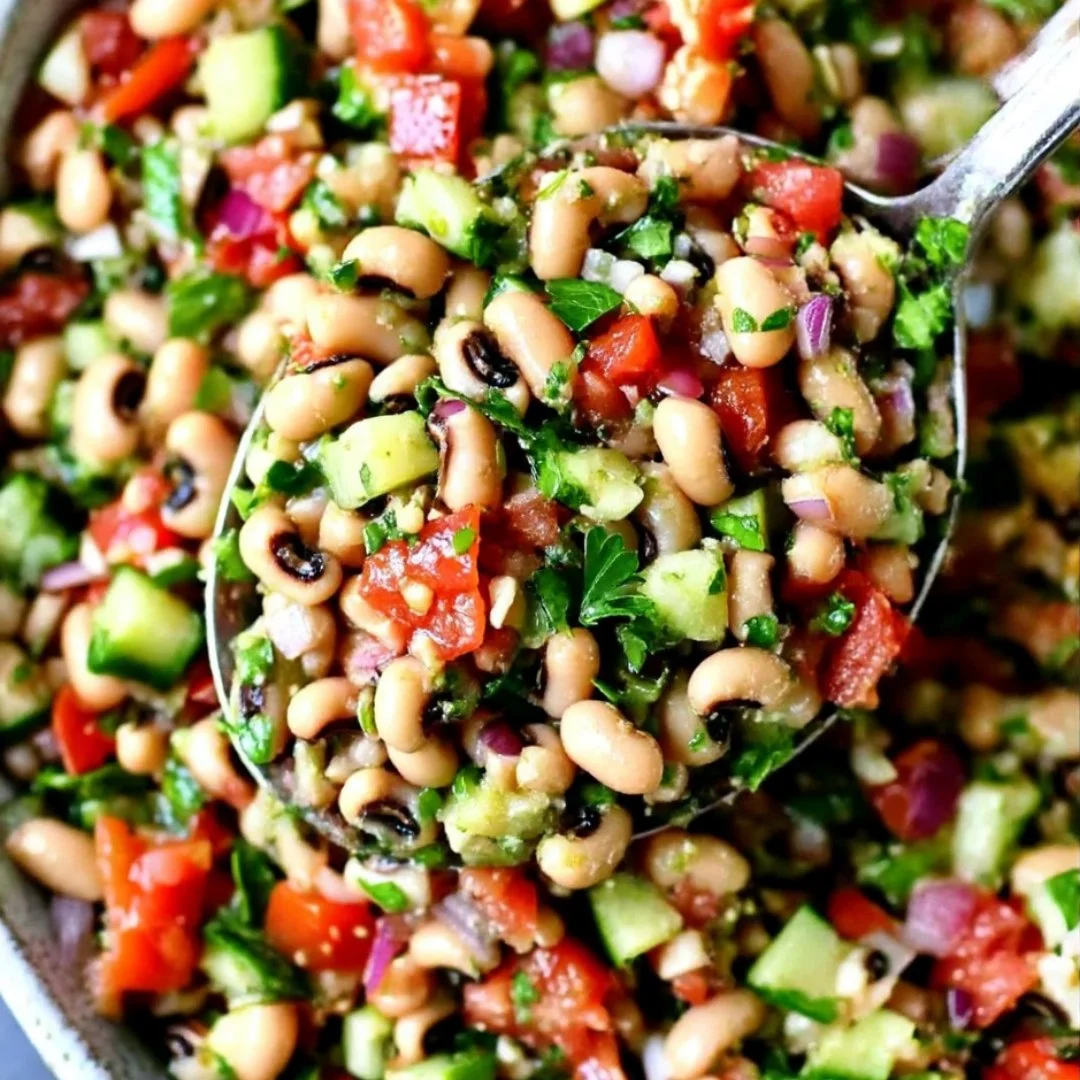 Spicy black-eyed pea salad with colorful vegetables in a serving bowl.