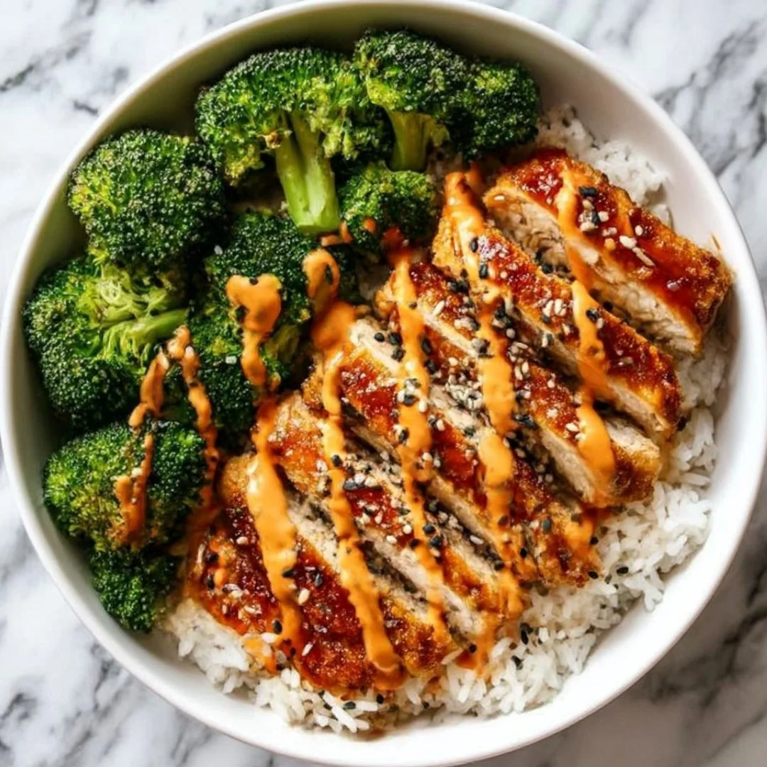 Sticky Chicken Rice Bowls topped with fresh herbs and served in a bowl.