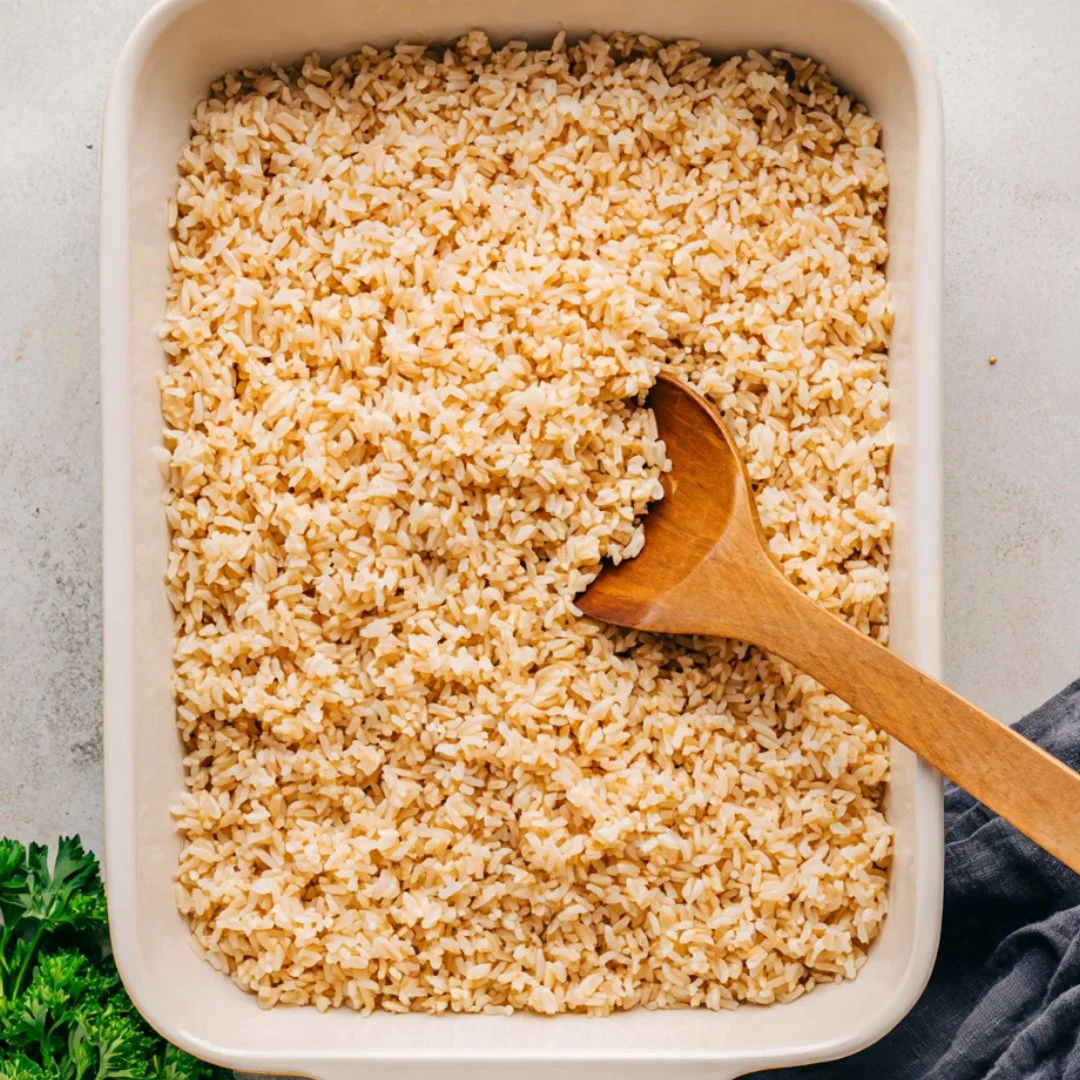 Baked brown rice dish served with vegetables and herbs