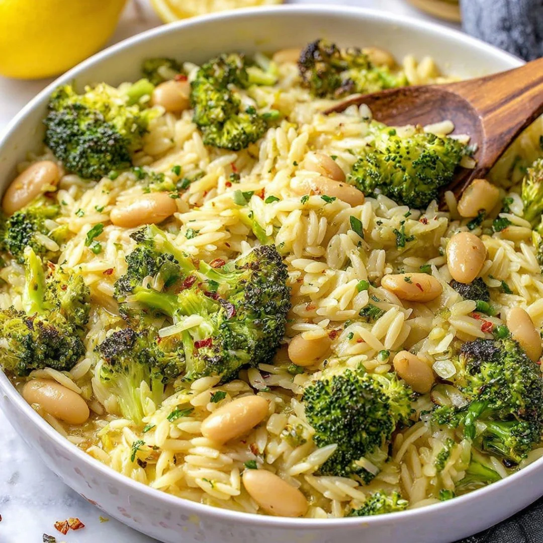 Plate of Broccoli Orzo with white beans, lemon zest, and grated Parmesan cheese