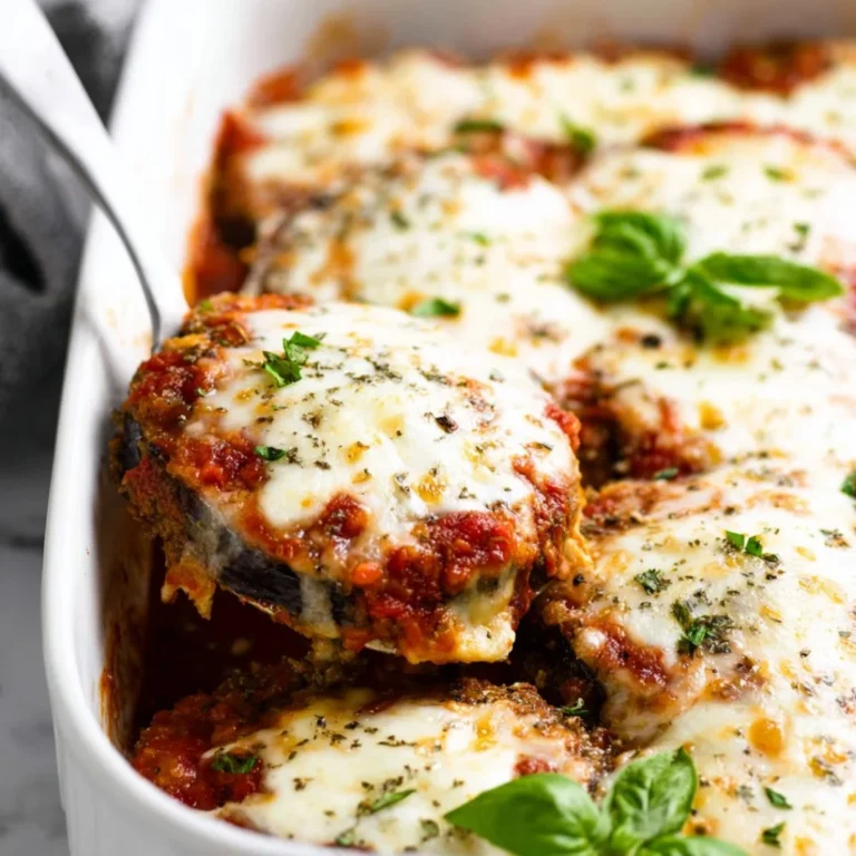 Delicious Eggplant Parmesan served with fresh basil and marinara sauce