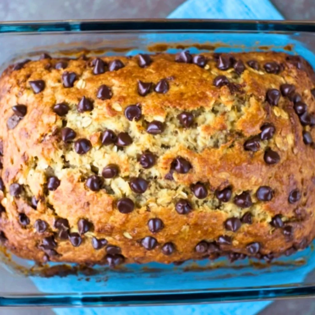 Healthy chocolate chip oatmeal banana bread loaf with fresh bananas and chocolate chips