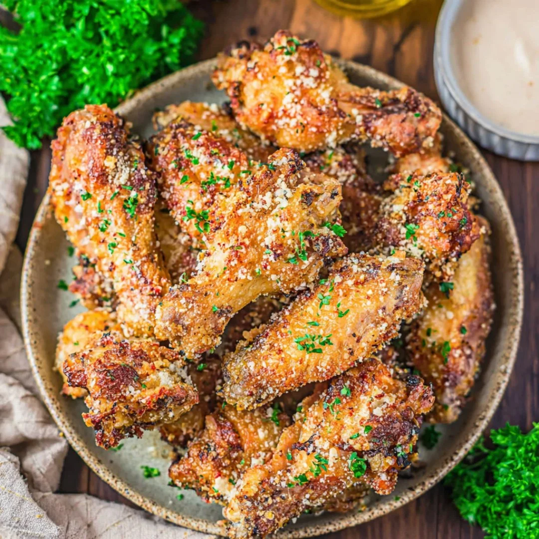 Delicious garlic parmesan wings garnished with herbs and spices