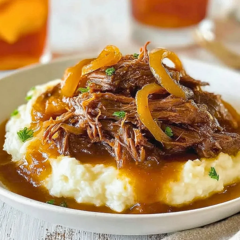 Delicious Crock Pot French Onion Pot Roast served with herbs and onions