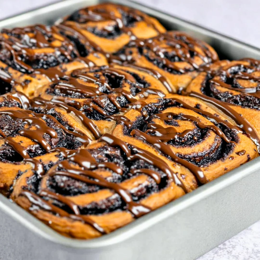 Fluffy chocolate cinnamon rolls drizzled with rich icing