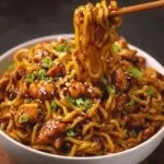 Delicious sticky garlic chicken noodles served in a bowl