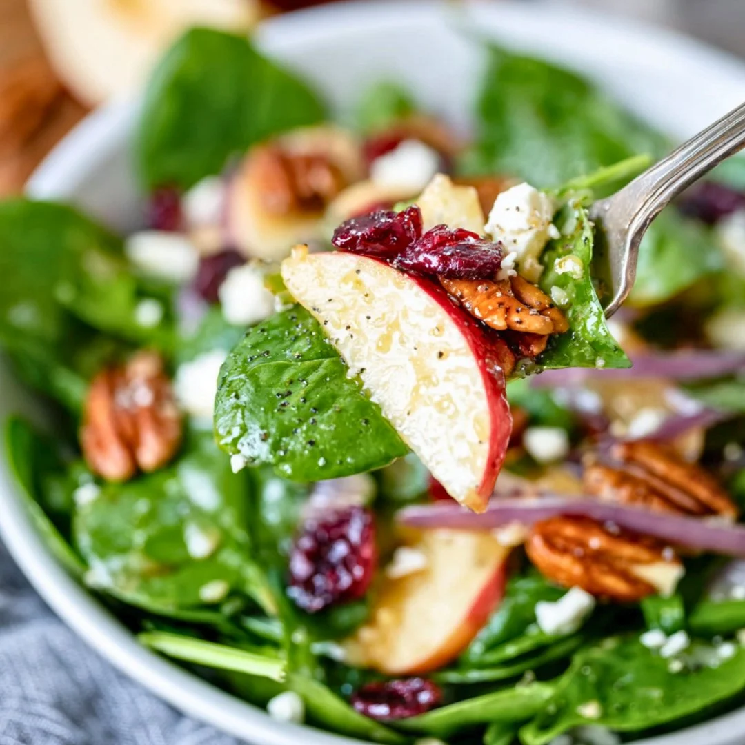 Delicious winter salad with apples and feta cheese on a wooden table