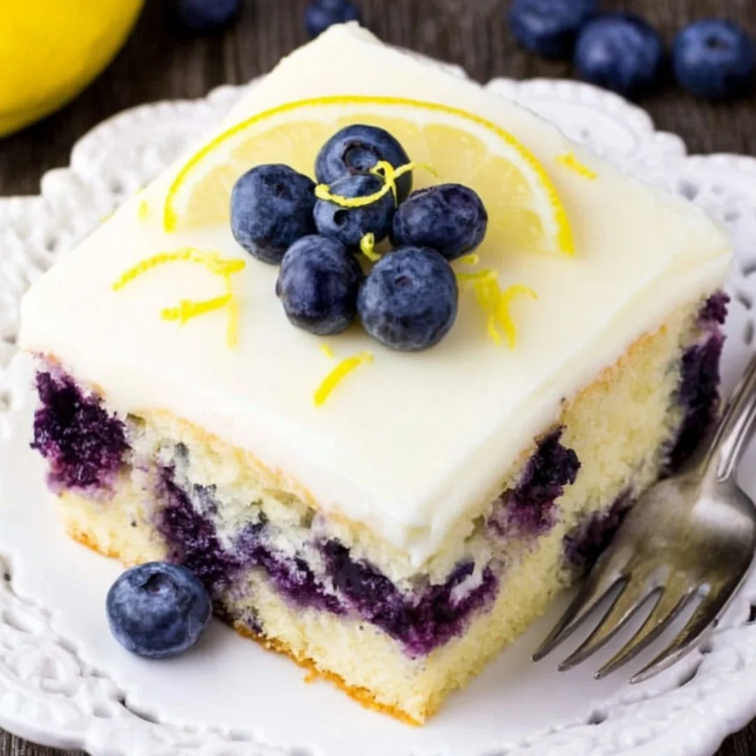Delicious Lemon Blueberry Cake topped with fresh blueberries and lemon zest
