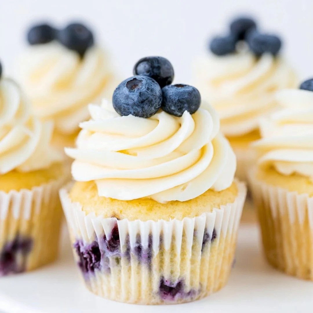 Lemon blueberry cupcakes with creamy frosting and fresh blueberries on top