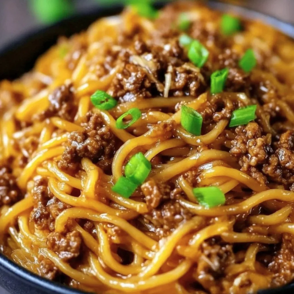 Delicious Mongolian ground beef noodles served with veggies and spices