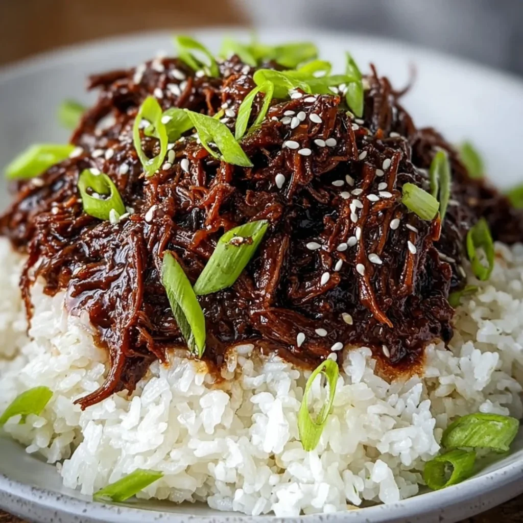 Delicious Slow Cooker Korean Beef served with rice and vegetables