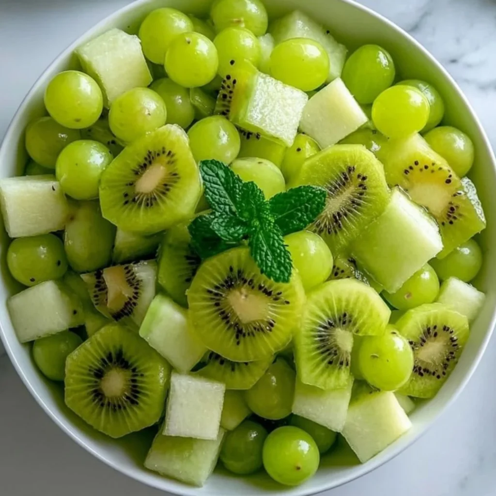 St. Patrick's Day themed green fruit salad with various fruits.