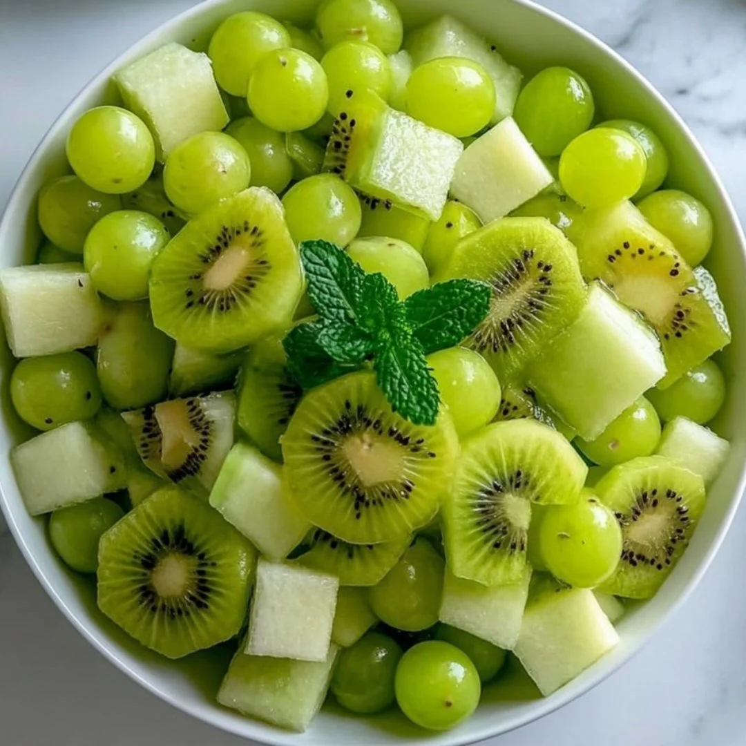 St. Patrick's Day themed green fruit salad with various fruits.