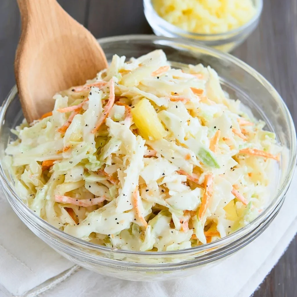 A vibrant bowl of Hawaiian Coleslaw with colorful vegetables and tropical flavors.