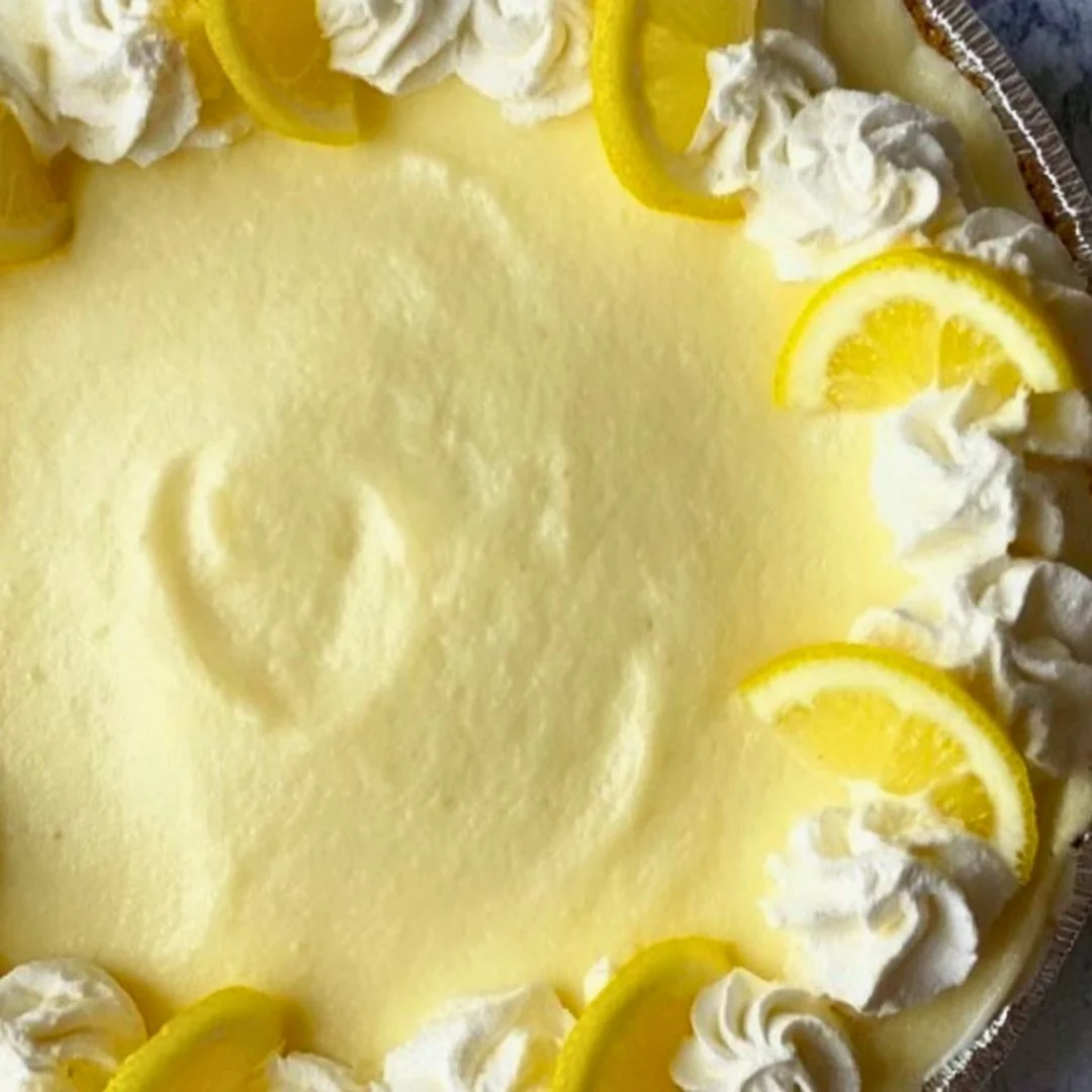 No Bake Lemon Cheesecake Cream Pie topped with fresh lemon slices.
