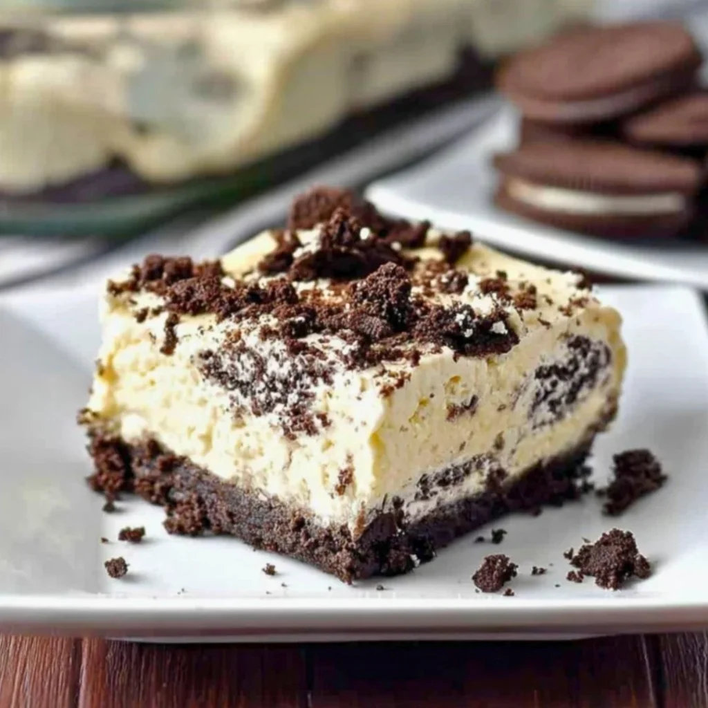 No Bake Oreo Cheesecake topped with crushed Oreo cookies