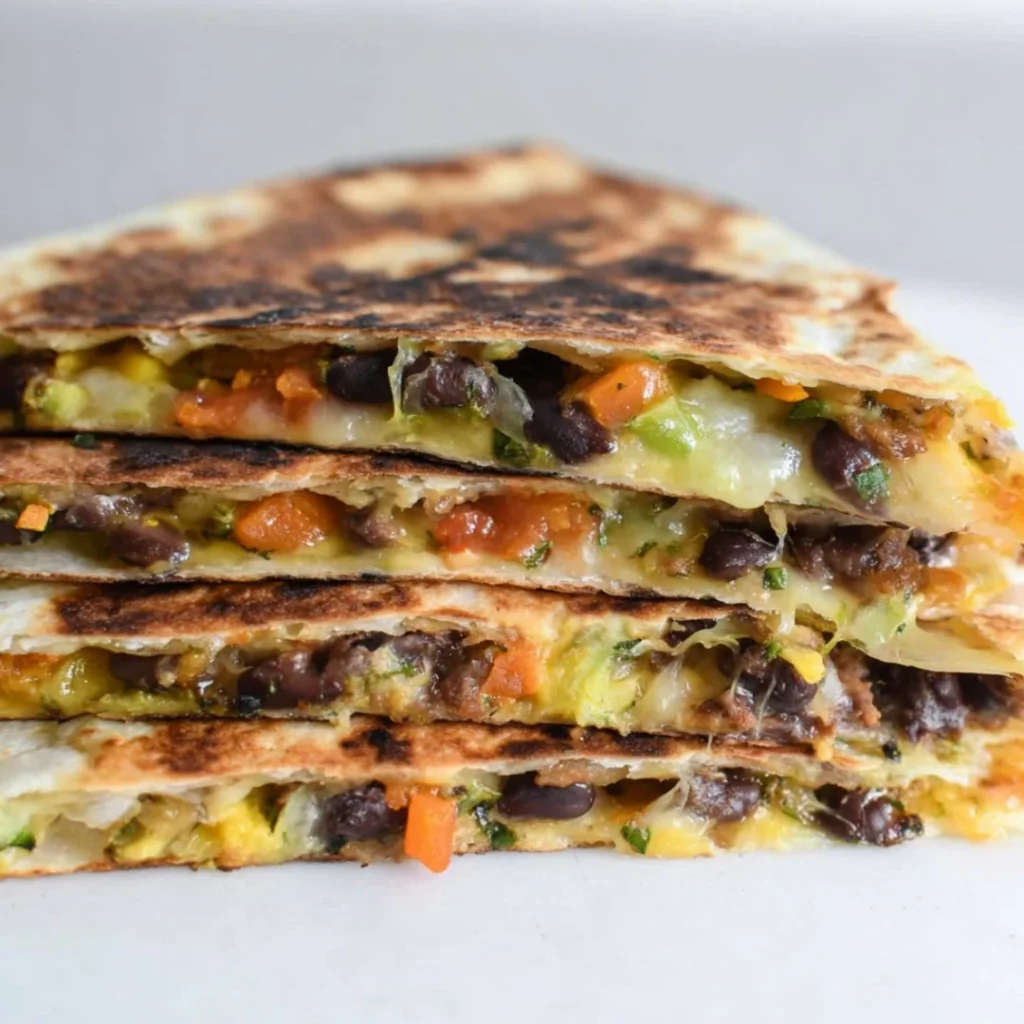 Delicious black bean veggie quesadilla filled with colorful vegetables and cheese