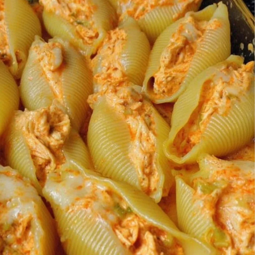 Buffalo Chicken Stuffed Shells topped with cheese and sauce