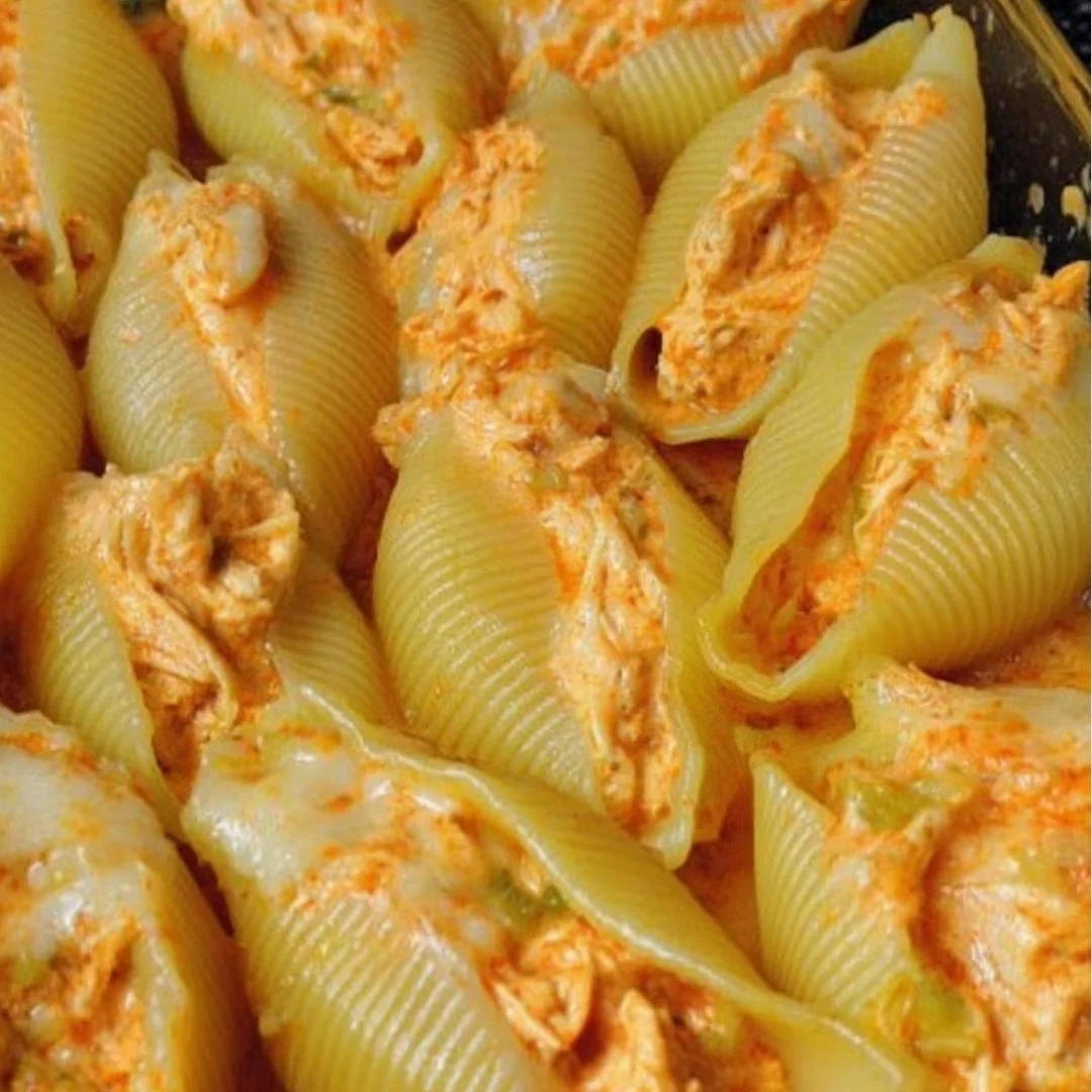 Buffalo Chicken Stuffed Shells topped with cheese and sauce