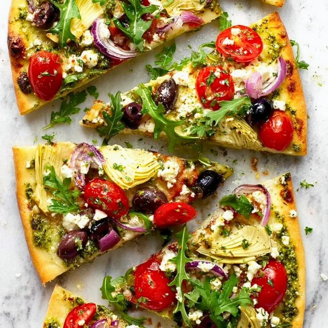 Mediterranean flatbread pizza topped with fresh vegetables and herbs