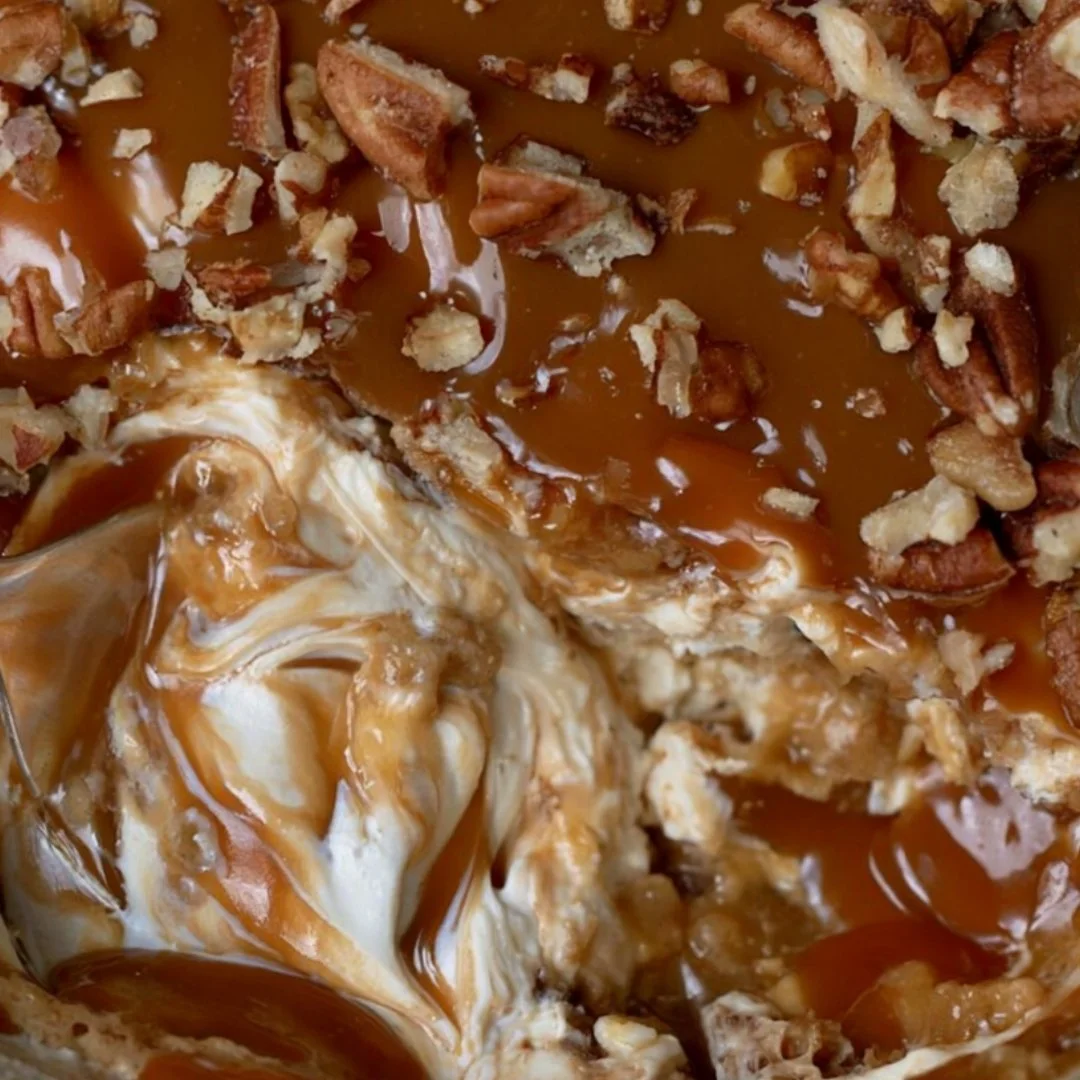 Delicious caramel apple cheesecake dip served with apple slices for dipping.