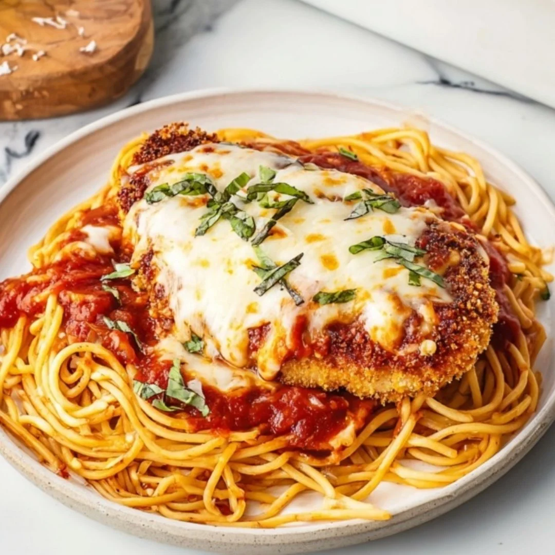 Delicious Chicken Parmesan topped with cheese and marinara sauce on a plate.
