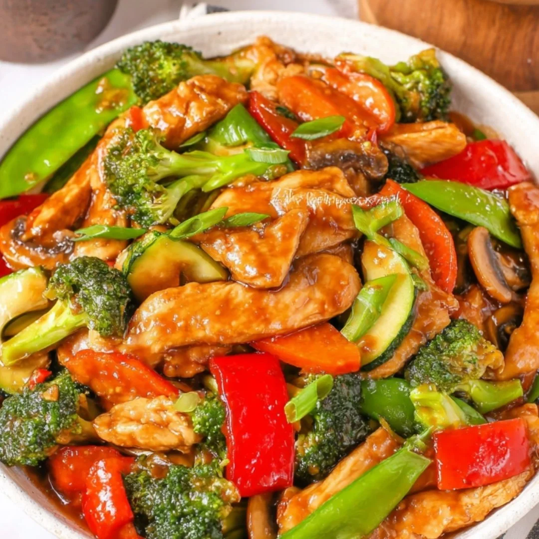 Chicken with mixed vegetables in a flavorful stir fry dish.