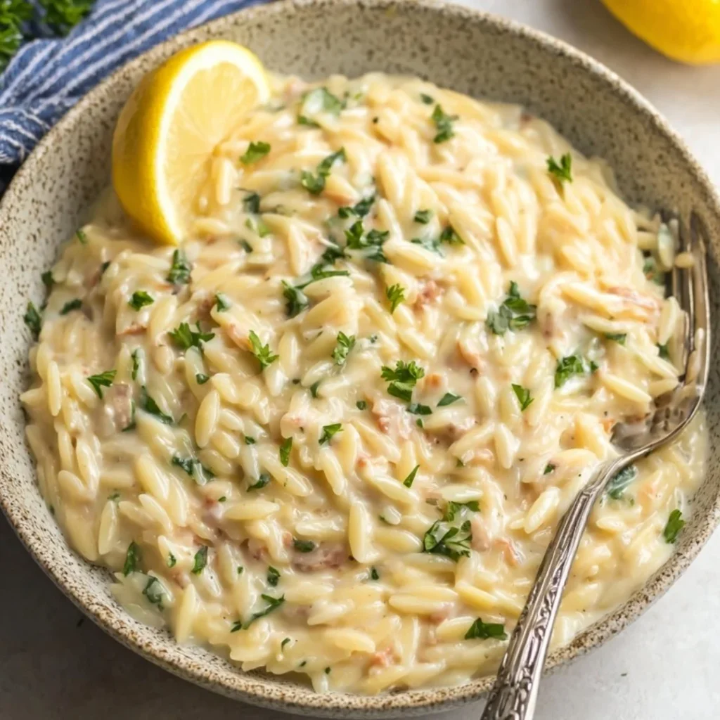 Delicious bowl of lemon orzo pasta with herbs and lemon zest