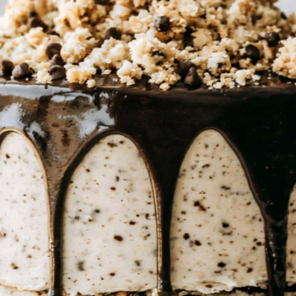 Delicious slice of Cookie Dough Cake topped with chocolate chips and dough