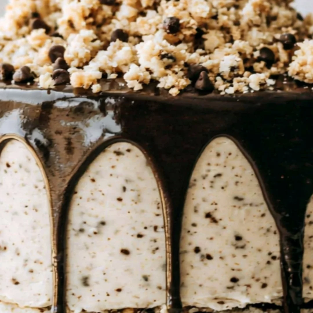 Delicious slice of Cookie Dough Cake topped with chocolate chips and dough