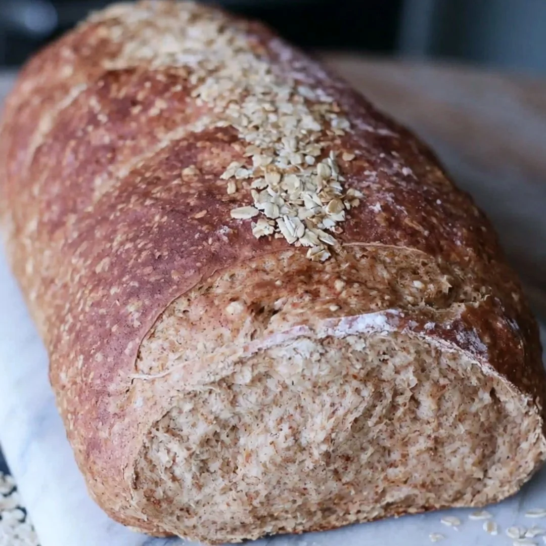 Loaf of homemade honey wheat bread, inspired by Cheesecake Factory recipe.